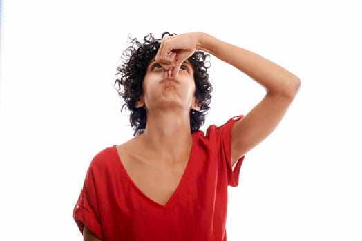 hispanic woman holding breath closing nose with fingers on white background