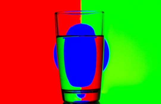 reflection of red green blue on a cup of water