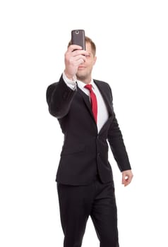 Handsome businessman taking a selfie with a mobile phone