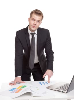 Handsome businessman standing behind the office desk
