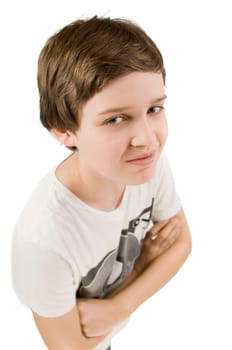 Upper body portrait of a young male teenager in a T-shirt and crossed arms in front of a white background smiling at the camera from an elevated view