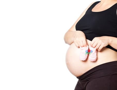 Pregnant woman with baby shoes isolated on white