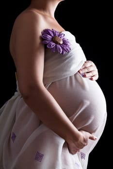 Belly of pregnant woman in white