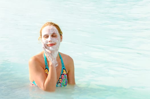 Beautiful young woman in Blue Lagoon geothermal spring , Iceland