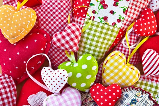Colorful hearts made of colorful fabrics as a background