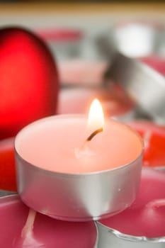Different colors of candles in a indoor composition.