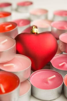 Different colors of candles in a indoor composition.