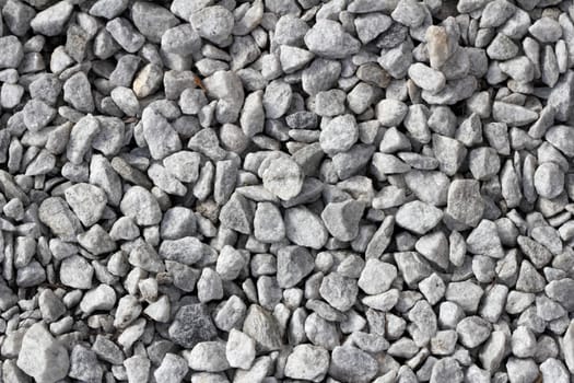 Gray white stones that act as gravel for drainage in flowerbeds and plantings in a wide variety of landscape areas.