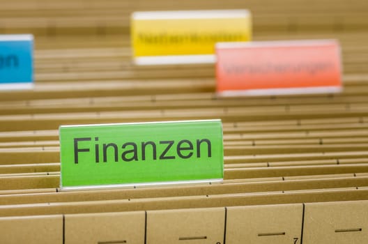 Hanging folders labeled Finance