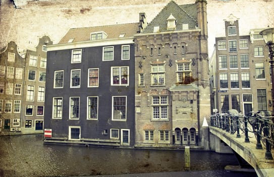Vintage photo of traditional dutch buildings and canal, in city of Amsterdam
