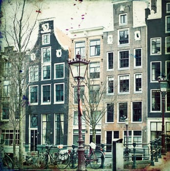 Vintage photo of traditional dutch buildings and canal, in city of Amsterdam