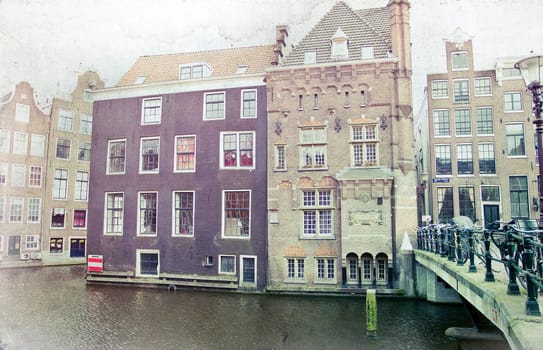 Vintage photo of traditional dutch buildings and canal, in city of Amsterdam