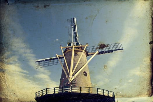 Vintage photo of dutch windmill under the blue sky of Netherlands