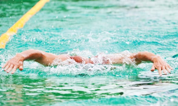 Swimmer performing the butterfly stroke  in olimpic basin