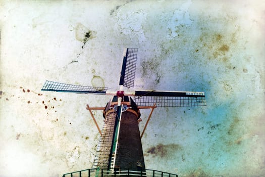 Vintage photo of dutch windmill under the blue sky of Netherlands