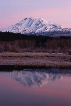 An amazing still lake scene in front of Mount Adams Washington
