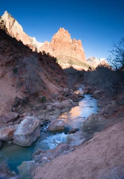 The light has not quite reached the vally int this vertical composition of early morning in the desert Southwest