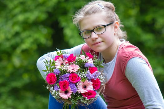 cute young girl with flowers - gift for the mother