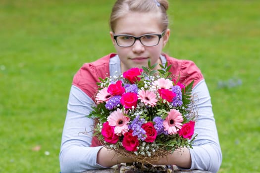cute young girl with flowers - gift for the mother