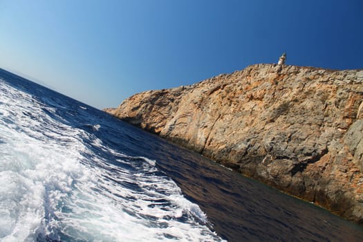 The sea, the rocks, a lighthouse