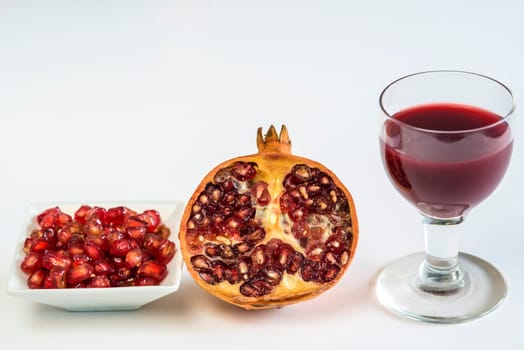 Pomegranate,halved fruit,seeds and juice