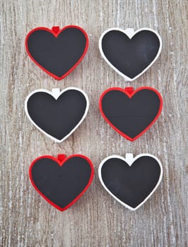 Small heart-shaped panels on a wooden background
