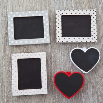 Small heart-shaped panels on a wooden background