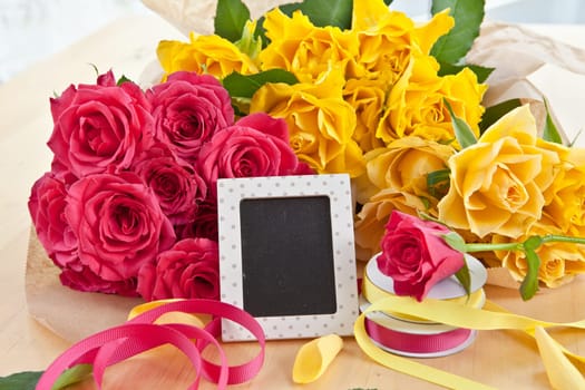Yellow and pink roses and a small panel with text space