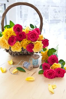 Pink and yellow roses in one basket
