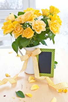 Fresh yellow roses in a white pot