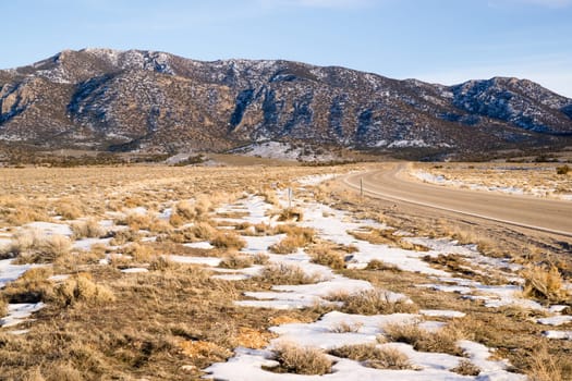 The road is clear and dry but winter waits to ice it up again