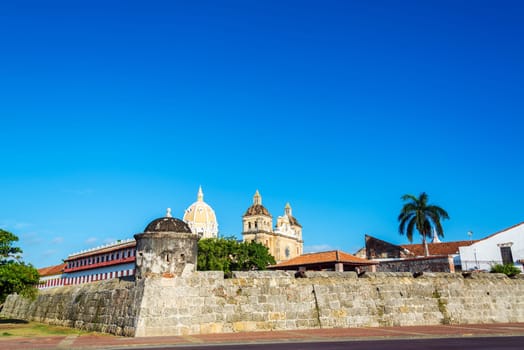 View of the walled city of Cartagena, Colombia with a large cathedral and some palm trees visible