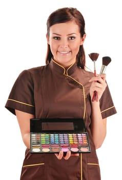 Professional beautician holding brushes
