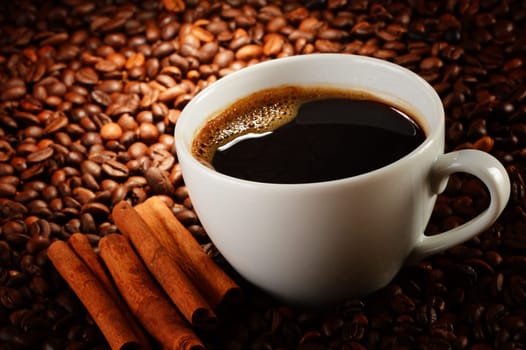 Composition with cup of coffee and beans