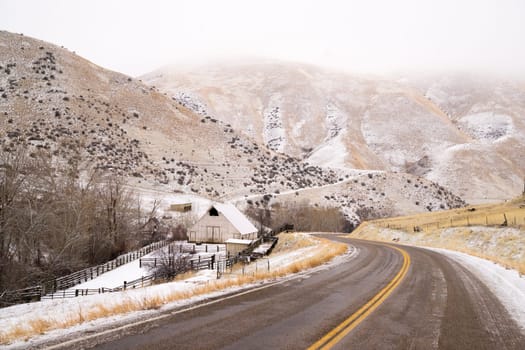 An icy road leads through country scene farm ranch hillside highway 71