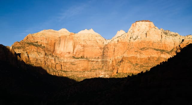 The light has not quite reached the valley int this vertical composition of early morning in the desert Southwest