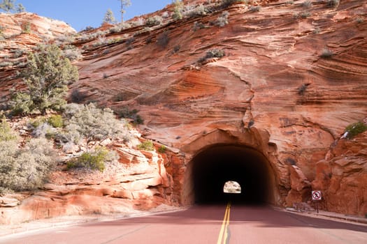 No pedestrians, they used the red rock from the mountainsides to make the asphalt for the road, color is not shifted in this photo.