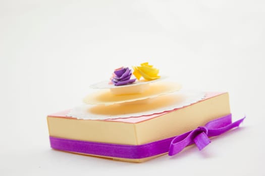 Handmake 3d origami gift box with different color roses on top.