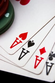 Cards laying around with poker chips on top.