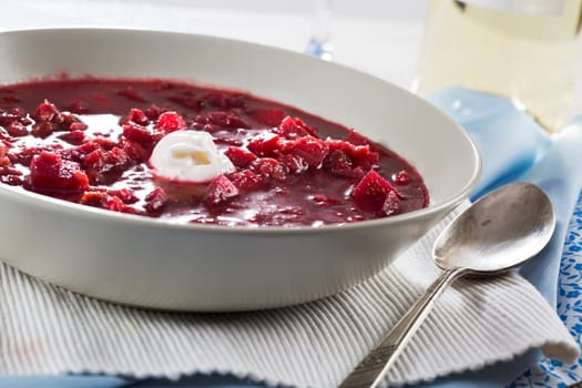 Bowl of borscht soup with dollop of cream.