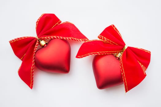 Heart shaped decoration with ribbons around it.