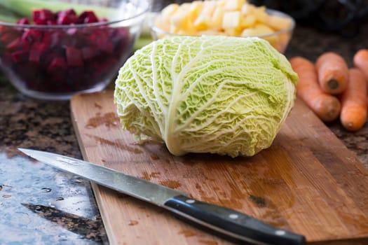 Head of savoy cabbage on cutting board ready to be chopped