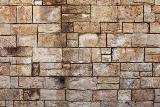 Old stone wall with weathered stones creating interesting patters