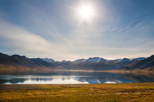 Icelandic landscape with volcanic rocks and green grass
