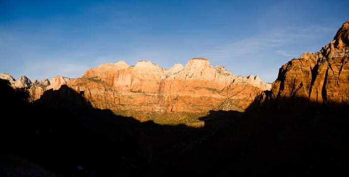 The light has not quite reached the valley int this vertical composition of early morning in the desert Southwest