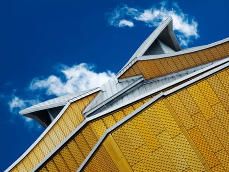 Detailed view of the façade of the Berlin Philharmonic Hall under blue sky with individual clouds