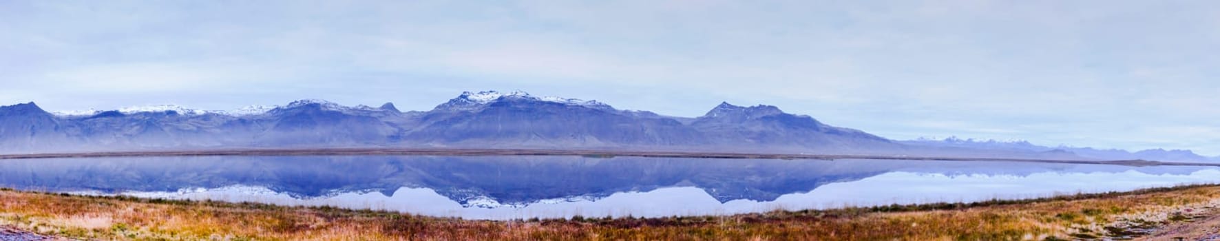 Icelandic landscape with volcanic rocks and green grass