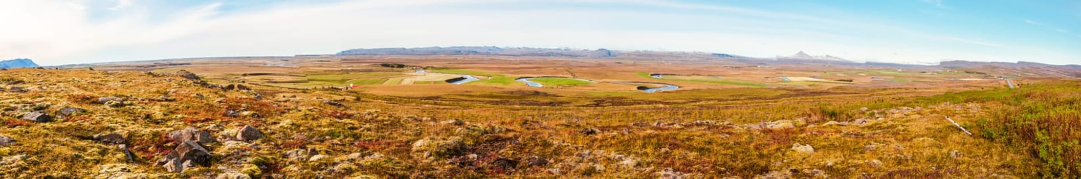 Icelandic landscape with volcanic rocks and green grass