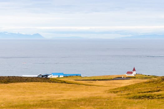 Icelandic landscape with volcanic rocks and green grass
