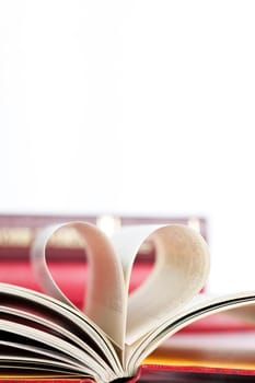 Close up on heart shaped book pages